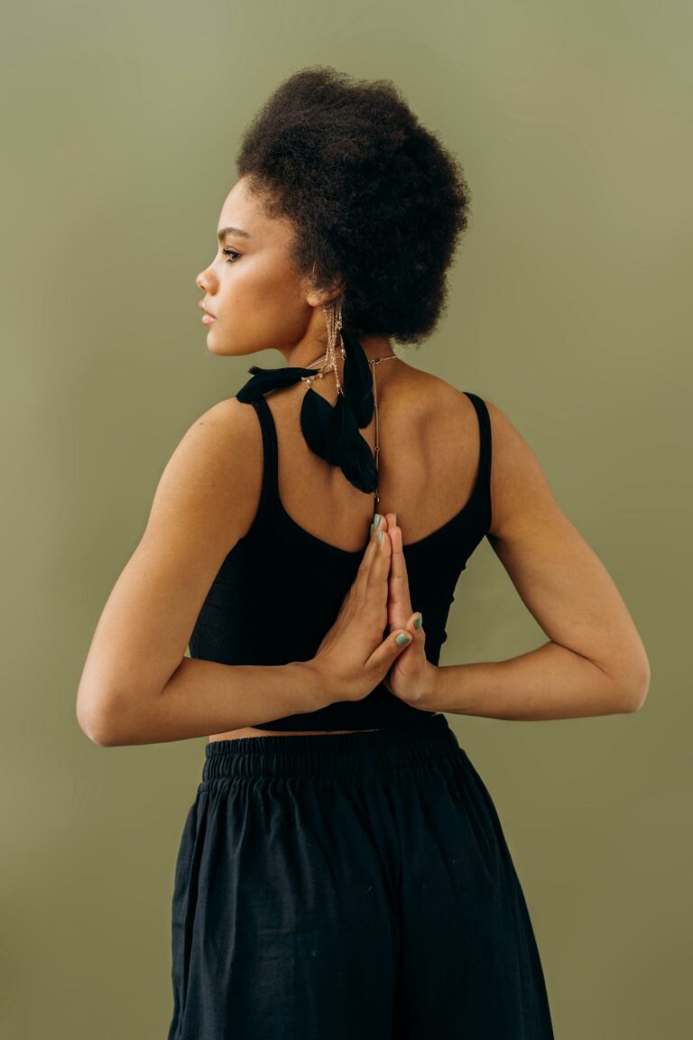 Woman practicing a tranquil yoga pose, symbolizing harmony and focus in a serene environment.